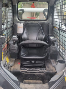 Low profile air seat solution for Bobcat 5650 skidsteer machine
