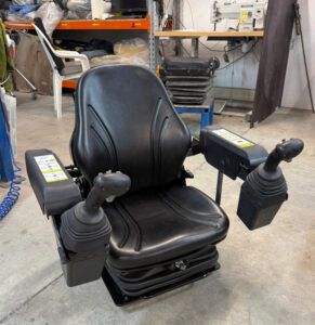 Low profile air seat solution for Bobcat 5650 skidsteer machine